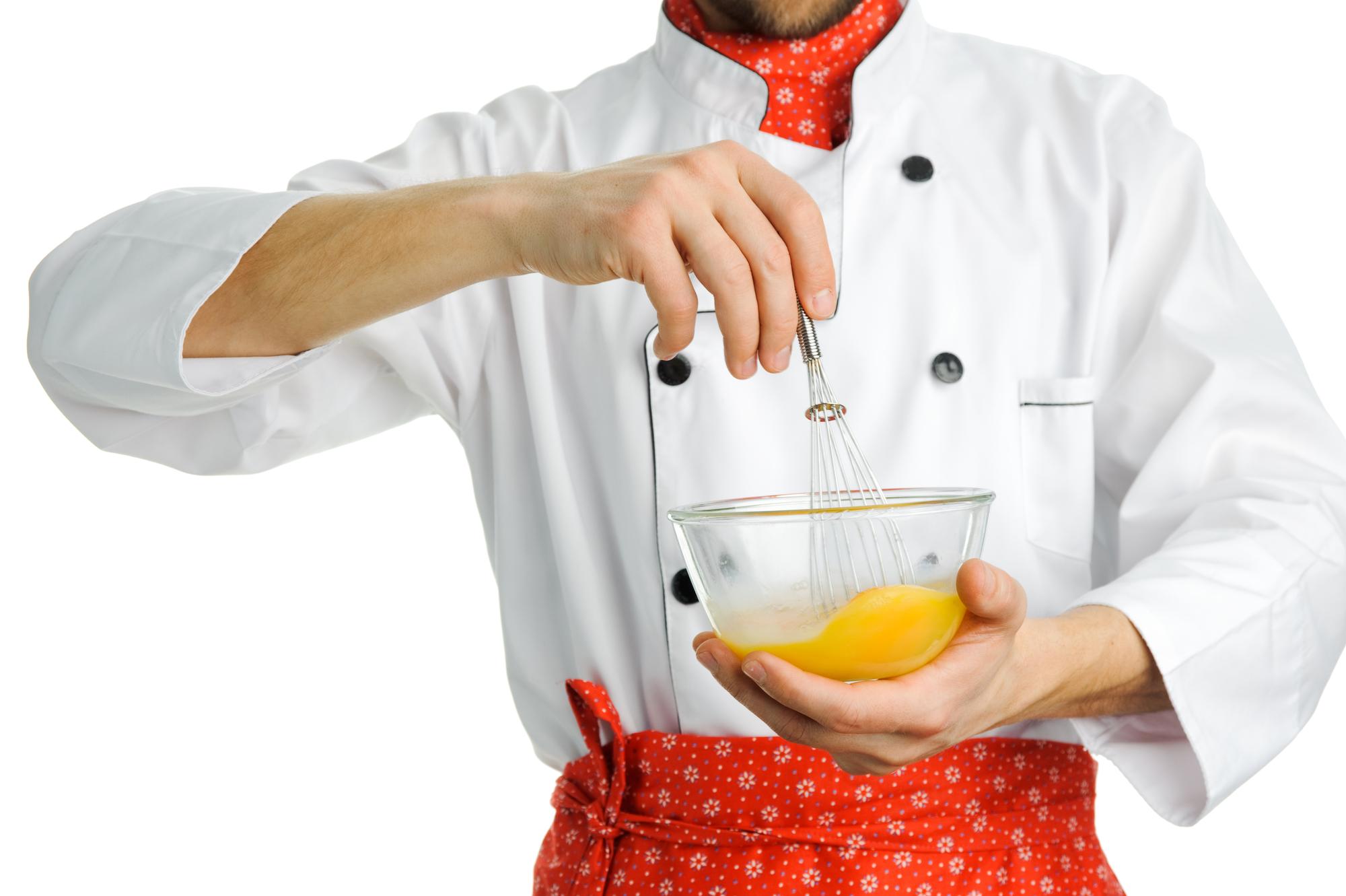 Chef demonstrating a bright cooking technique in a modern kitchen